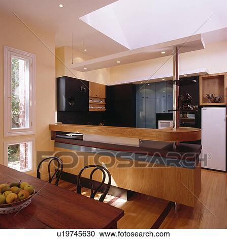 Stock Image - Open-plan modern kitchen and dining room. Fotosearch