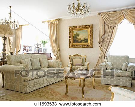 Opulent neutral country living room with damask sofa and patterned armchair View Large Photo Image Stock Image - Opulent neutral country living room with damask sofa and patterned armchair. Fotosearch