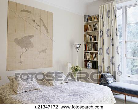 Oriental style picture above bed with blue and white quilt in country bedroom View Large Photo Image Stock Image - Oriental style picture above bed with blue and white quilt in country bedroom. Fotosearch