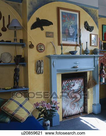 Painted wooden firescreen in blue wooden fireplace in yellow living room View Large Photo Image Stock Image - Painted wooden firescreen in blue wooden fireplace in yellow living room. Fotosearch