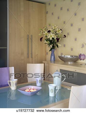 Pale blue coffeepot and cups on glass-topped table in small dining room View Large Photo Image Stock Image - Pale blue coffeepot and cups on glass-topped table in small dining room. Fotosearch