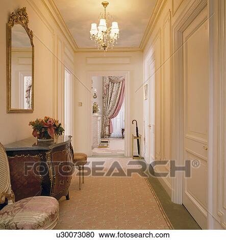 Pale pink floral carpet on townhouse landing with mirror above antique chest-of-drawers View Large Photo Image Stock Image - Pale pink floral carpet on townhouse landing with mirror above antique chest-of-drawers . Fotosearch