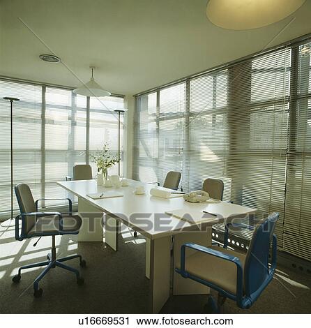 Pale wood table and slatted blinds in meeting room in modern commercial office View Large Photo Image Stock Image - Pale wood table and slatted blinds in meeting room in modern commercial office. Fotosearch