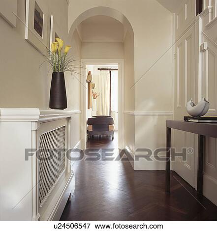 Parquet flooring and cream radiator cover in traditional cream townhouse hall View Large Photo Image Stock Photo - Parquet flooring and cream radiator cover in traditional cream townhouse hall. Fotosearch