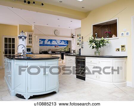 Pastel Blue Island Unit In Pale Yellow Kitchen Extension With Fitted Cream Units Stock Image U10885213 Fotosearch