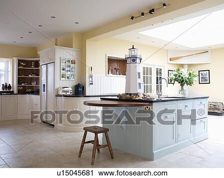 Stock Photography Of Pastel Blue Island Unit In Pale Yellow Kitchen Pastel Blue Island Unit In Pale Yellow Kitchen Extension With Ed Cream Units And Limestone Flooring