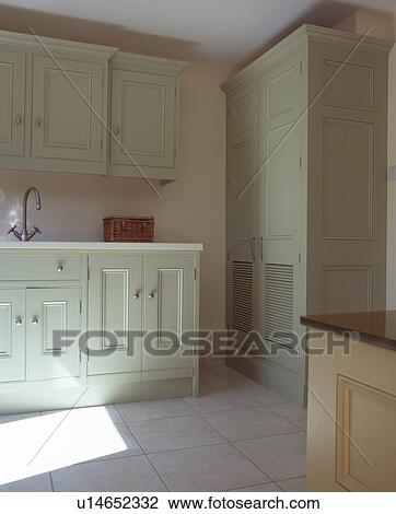 Pastel green fitted units in cream kitchen View Large Photo Image Stock Image - Pastel green fitted units in cream kitchen. Fotosearch