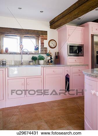 Pastel pink fitted units and cupboards in white country kitchen with butler's sink View Large Photo Image Stock Image - Pastel pink fitted units and cupboards in white country kitchen with butler's sink. Fotosearch