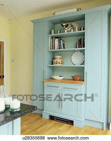 Stock Photo - Pastel turquoise fitted dresser in country kitchen. Fotosearch