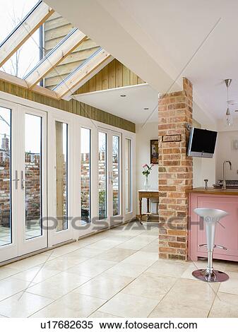 Patio doors and limestone flooring in modern kitchen extension with glass roof View Large Photo Image Stock Photography - Patio doors and limestone flooring in modern kitchen extension with glass roof. Fotosearch