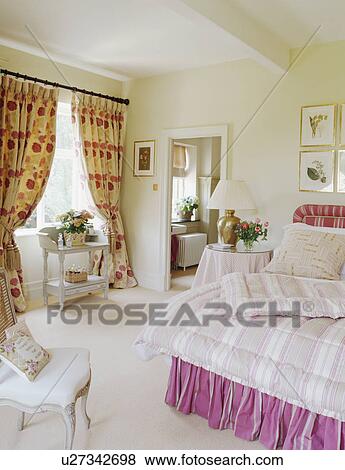 Patterned Curtains And Pink Bedlinen In Cream Country Bedroom