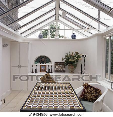 Patterned table in modern dining room extension with glass roof View Large Photo Image Stock Photograph - Patterned table in modern dining room extension with glass roof. Fotosearch