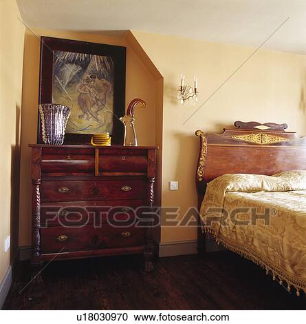 Picture above antique mahogany chest of drawers in alcove beside bed with ornate headboard View Large Photo Image Stock Image - Picture above antique mahogany chest of drawers in alcove beside bed with ornate headboard. Fotosearch