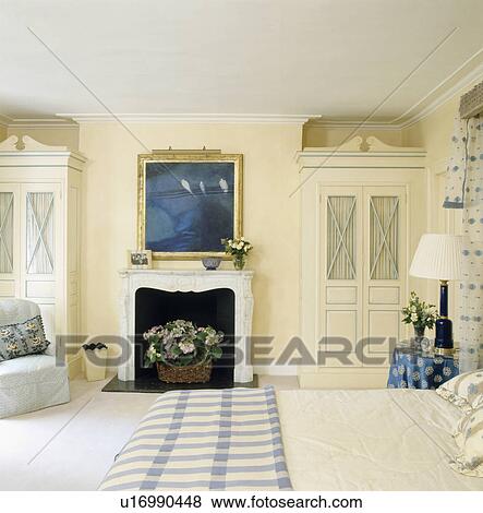 Stock Photo - Picture above fireplace in traditional bedroom. Fotosearch