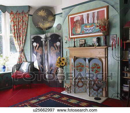 Picture above pine fireplace with painted folding screen in green eighties living room with spongeing effect walls View Large Photo Image Stock Photo - Picture above pine fireplace with painted folding screen in green eighties living room with spongeing effect walls. Fotosearch