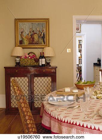 Stock Image - Picture above small sideboard in country dining room. Fotosearch
