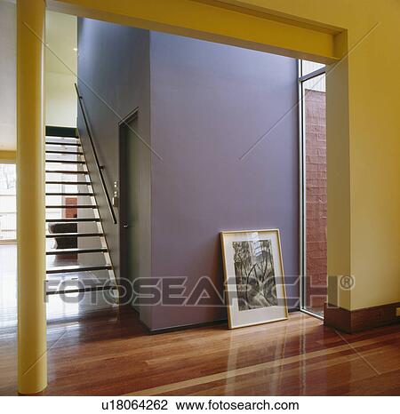 Picture against mauve wall in modern hall with opentread staircase View Large Photo Image Stock Image - Picture against mauve wall in modern hall with opentread staircase. Fotosearch