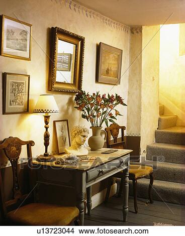 Pictures above console table in traditional cream hall View Large Photo Image Picture - Pictures above console table in traditional cream hall. Fotosearch