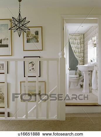 Stock Photo - Pictures on walls on white landing. Fotosearch