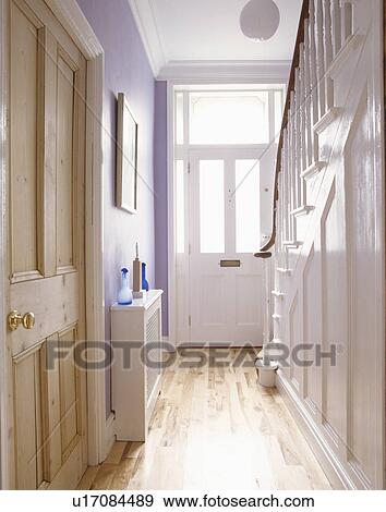 Pine doors and laminate wood flooring in pale mauve hall View Large Photo Image Stock Photo - Pine doors and laminate wood flooring in pale mauve hall. Fotosearch