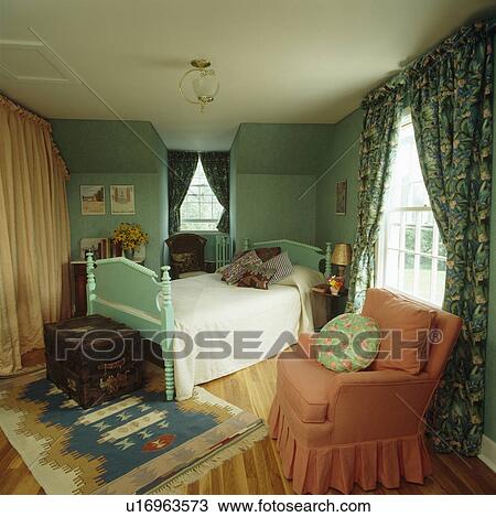 Pink armchair and turquoise wooden bed in turquoise bedroom View Large Photo Image Stock Image - Pink armchair and turquoise wooden bed in turquoise bedroom. Fotosearch