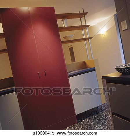 Stock Photography - Pink cupboard doors in modern kitchen. Fotosearch