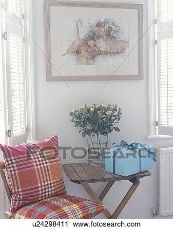 Pink roses and turquoise gift wrapped present on wooden table beside chair with red checked cushions View Large Photo Image Stock Image - Pink roses and turquoise gift wrapped present on wooden table beside chair with red checked cushions. Fotosearch