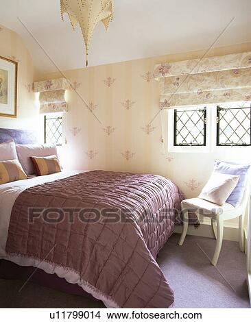 Pink silk quilt and hand-stencilled walls in country bedroom View Large Photo Image Picture - Pink silk quilt and hand-stencilled walls in country bedroom. Fotosearch