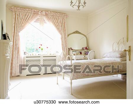 Stock Photography Of Pink Toile De Jouy Curtains And Bedlinen In Pink Toile De Jouy Curtains And Bedlinen In Cream Country Bedroom With Carpet Wrought Iron Bed