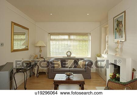 Pinoleum blind on window above grey sofa in cream living room View Large Photo Image Picture - Pinoleum blind on window above grey sofa in cream living room. Fotosearch