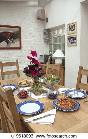 Place settings on wooden table in kitchen dining room View Large Photo Image Stock Image - Place settings on wooden table in kitchen dining room. Fotosearch