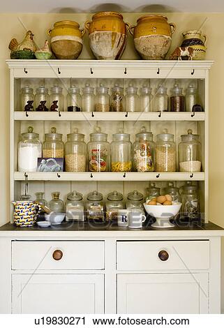 Provencal Pots And Rows Of Glass Kitchen Storage Jars On Shelves