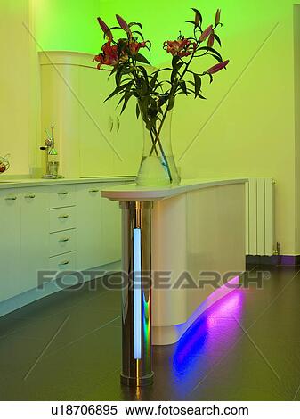 Purple and blue fluorescent lighting below island unit in modern kitchen with green uplighting View Large Photo Image Stock Photography - Purple and blue fluorescent lighting below island unit in modern kitchen with green uplighting. Fotosearch