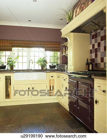 Stock Photography Of Quarry Tiled Floor In Purple Kitchen With Cream Stock Photography Quarry Tiled Floor In Purple Kitchen With Cream Ed Units And