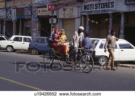 Stock Image - Rajastani women travelling by bicycle taxi. Fotosearch