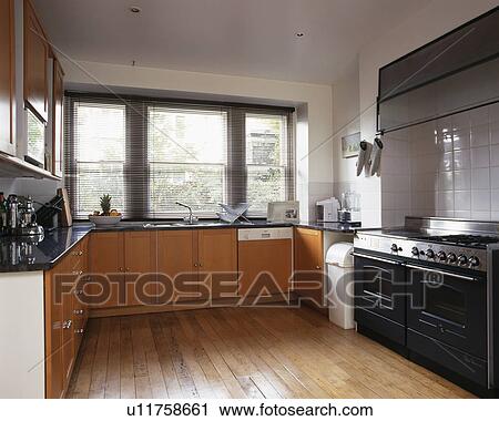 Stock Image - Range oven in modern kitchen with wooden flooring. Fotosearch