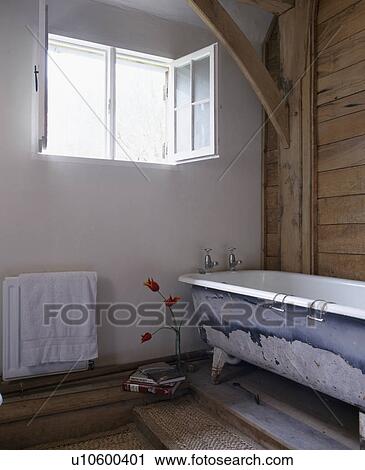 Reclaimed rolltop bath in rustic bathroom View Large Photo Image Stock Image - Reclaimed rolltop bath in rustic bathroom. Fotosearch