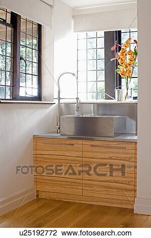 Rectangular stainless-steel sink on steel worktop below window in modern country kitchen View Large Photo Image Stock Image - Rectangular stainless-steel sink on steel worktop below window in modern country kitchen. Fotosearch