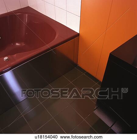 Red Bath In Orange And White And White Bathroom With Green Floor Tiles Stock Image U18154040 Fotosearch