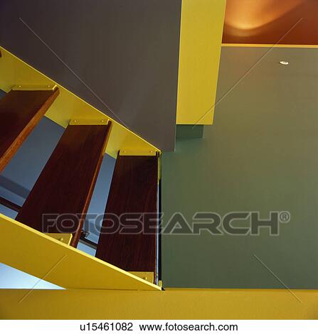 Stock Image - Red treads on modern yellow staircase. Fotosearch