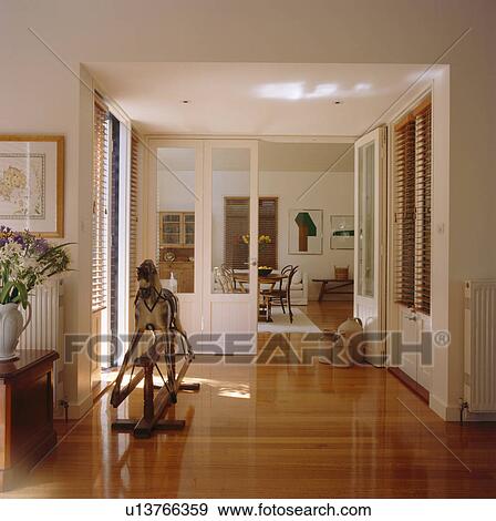 Rocking horse and polished wooden floor in modern white hall View Large Photo Image Stock Photo - Rocking horse and polished wooden floor in modern white hall. Fotosearch