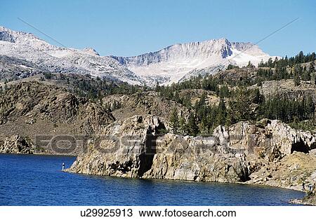 Rocky shoreline with backdrop of mountains in Yosemite National Park in California View Large Photo Image Stock Image - Rocky shoreline with backdrop of mountains in Yosemite National Park in California . Fotosearch