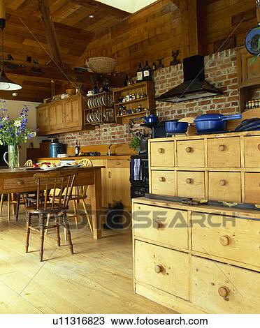 Stock Image - Set of old pine drawers in country kitchen. Fotosearch