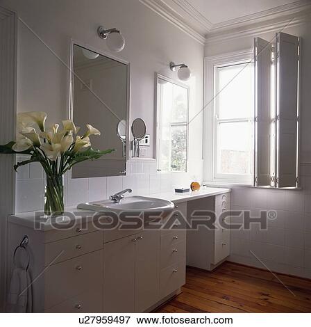 Shutters on window in modern white bathroom View Large Photo Image Stock Photo - Shutters on window in modern white bathroom. Fotosearch