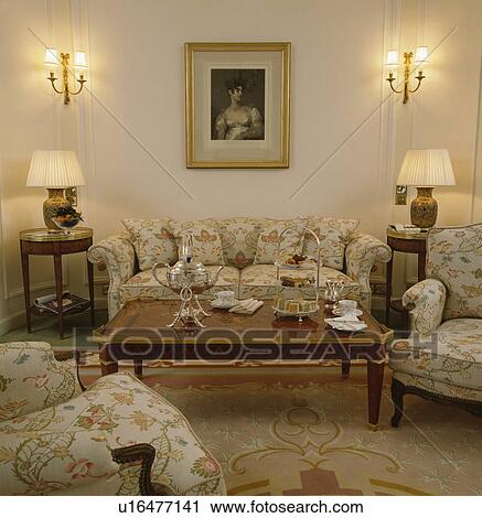 Silver samovar and teaset on coffee table in front of floral sofa in townhouse drawing room View Large Photo Image Stock Image - Silver samovar and teaset on coffee table in front of floral sofa in townhouse drawing room. Fotosearch