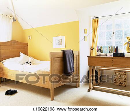 Single pine bed in child's yellow bedroom View Large Photo Image Stock Photo - Single pine bed in child's yellow bedroom. Fotosearch