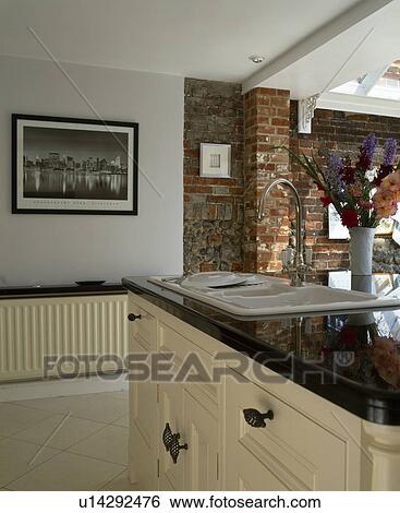 Sink in island unit with black granite worktop in townhouse kitchen View Large Photo Image Stock Photograph - Sink in island unit with black granite worktop in townhouse kitchen. Fotosearch