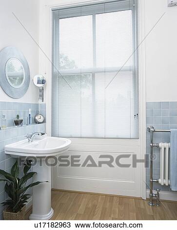 Slatted blind on window in modern white bathroom View Large Photo Image Stock Image - Slatted blind on window in modern white bathroom. Fotosearch