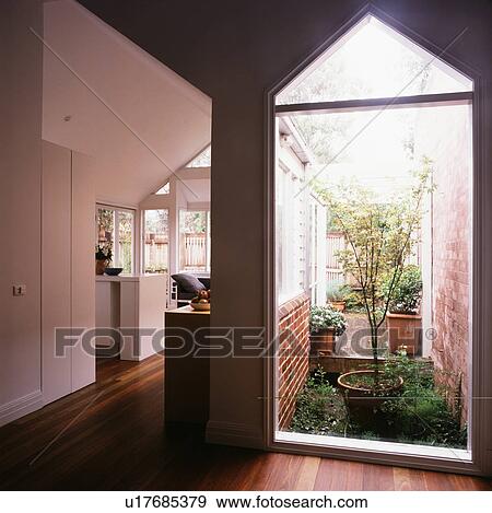 Stock Photo - Small atrium in modern white hall. Fotosearch