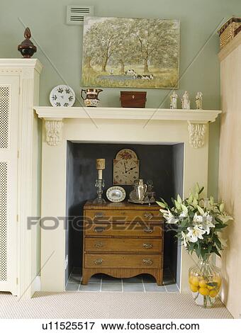 Small chest-of-drawers below white fireplace View Large Photo Image Stock Photo - Small chest-of-drawers below white fireplace. Fotosearch